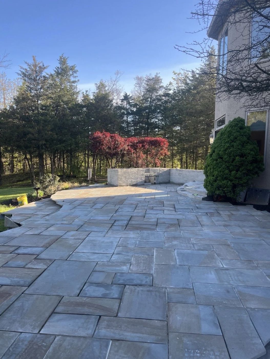 Natural stone patio surrounded by plantings
